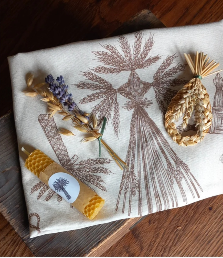 Lammas harvest celebration altar set featuring a harvest token made from UK grown maris widgeon wheat straw, beeswax candle, posie of oats and dried lavender and either a corndollies tea cloth/alter cloth or tote bag.
