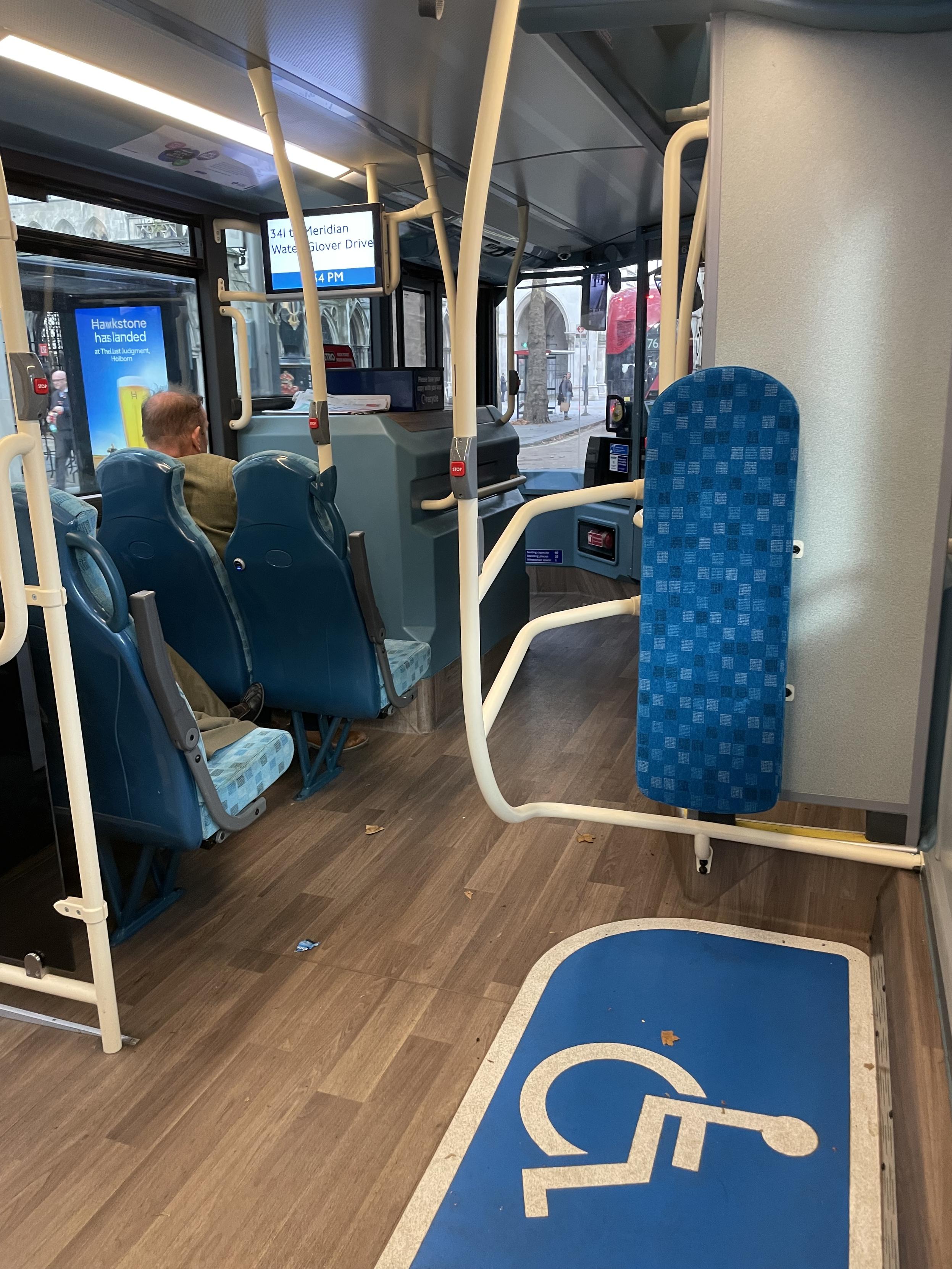 Cramped interior bay of a Wright StreetDeck Electroliner bus on Transport for London’s 341 route. Note the tacky, foolish “woodgrain” flooring.