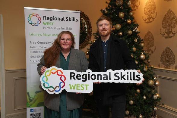 Ainslie Peters from CREW and Denman Rooke from RÚCACH holding a sign for Regional Skills West.