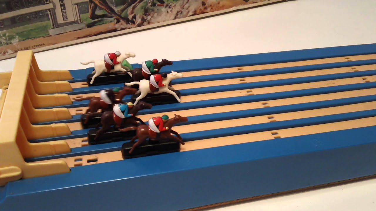 Antique horseracing game from the fiftees, small horse figures on a plastic track, that can be slid forward.