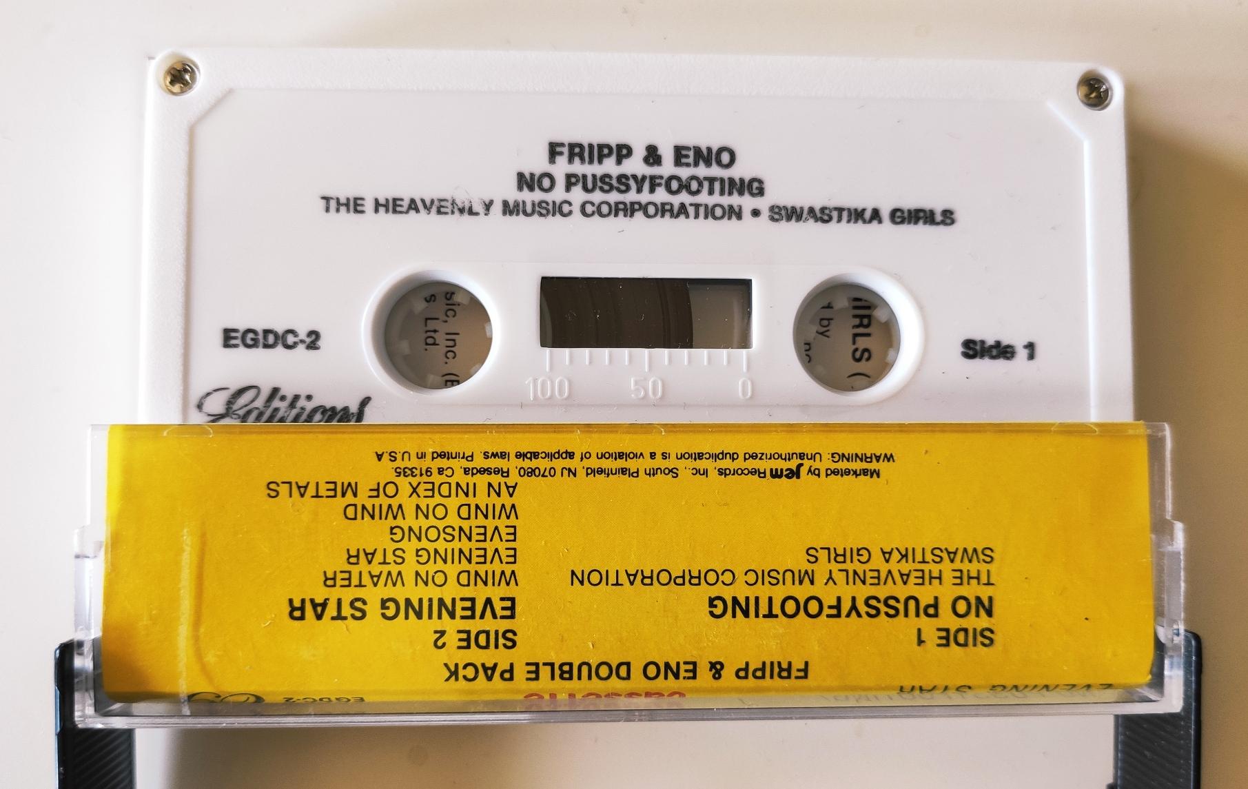 White inner cassette inserted in yellow sleeve with track titles